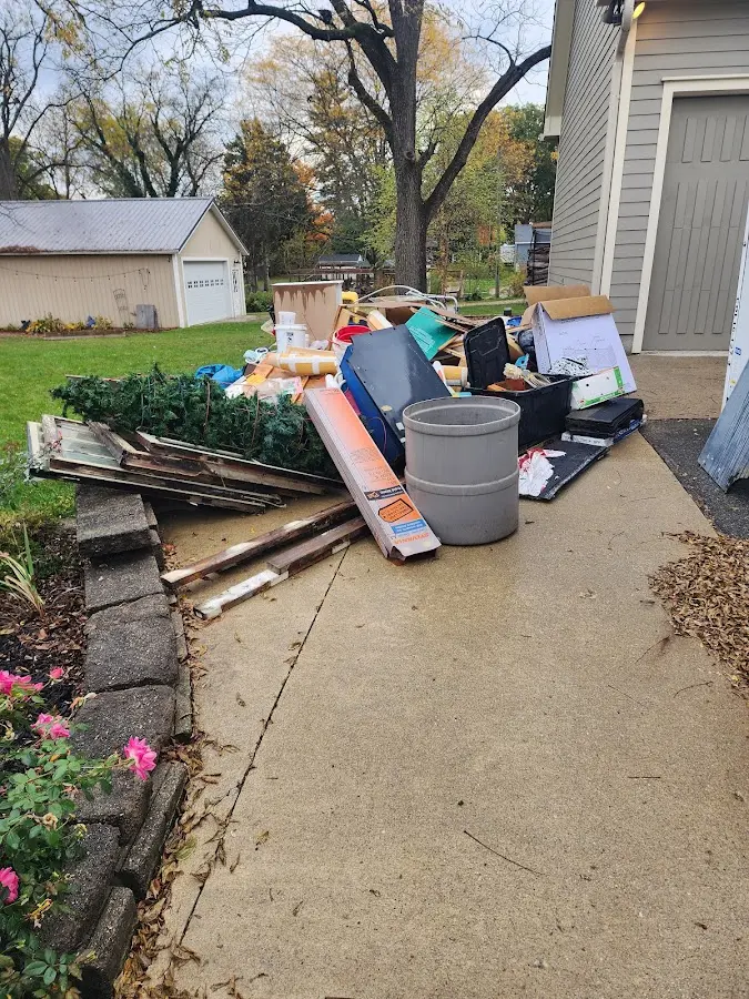 Dumpster being loaded with debris for Estate Cleanout Dumpster Rental in Brent